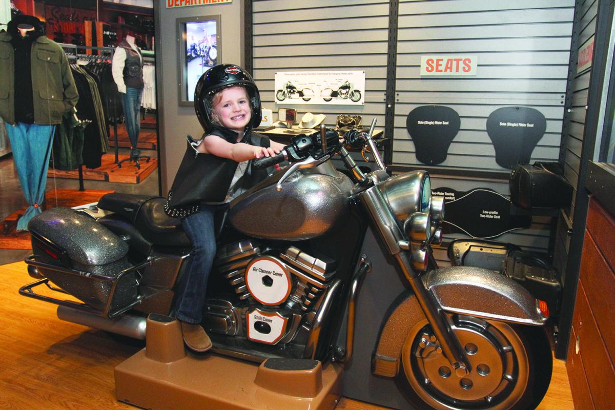 Harley Davidson Orlando Science Center smiling girl on bike 